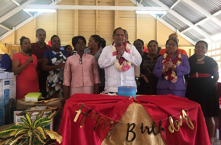 Prime Minister Moses Nagamootoo and his wife, Sita Nagamootoo, are surrounded by staff of the Auchlyne Primary School as he celebrated his birthday