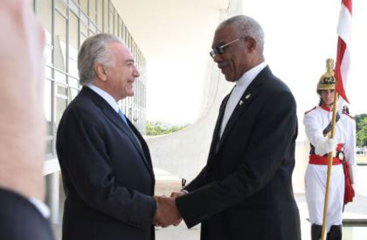 Brazil’s President Michel Temer greets President David Granger on his arrival in Brazil last week (DPI photo)