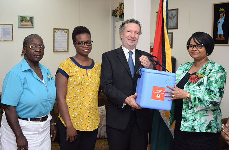 Minister of Public Health Volda Lawrence, receiving a portion of the MMR vaccines from Brazilian Ambassador to Guyana, Lineu Pupo de Paula in the presence of Director of Family Healthcare services in the Ministry, Dr. Ertenesia Hamilton.