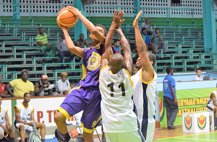 Nathan Saul goes up against two Plaisance Guardians defenders, during his 18-point game performance on Wednesday at the Cliff Anderson Sports Hall.