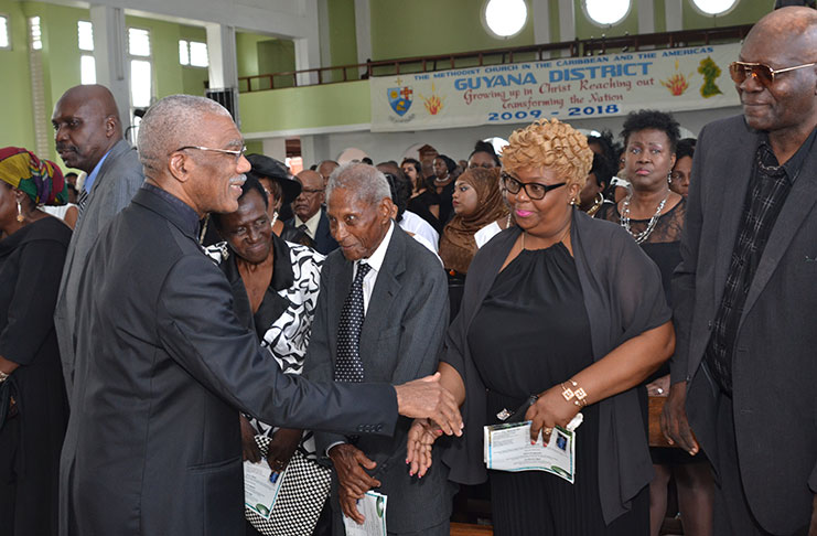 President David Granger greeting relatives and friends of the late Sandra Jones