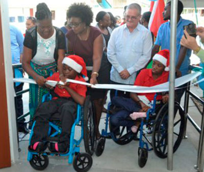 Students from the Ptolemy Reid Rehabilitation Centre cut the ribbon to commission the training facility