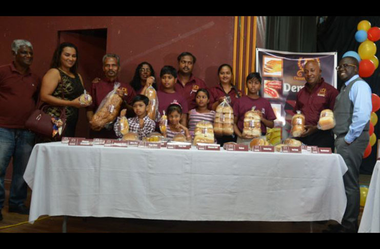 Demerara Bakery General Manager, Kenneth Scrubb with family and employees showcasing the delicious bread and pastries produced by the company