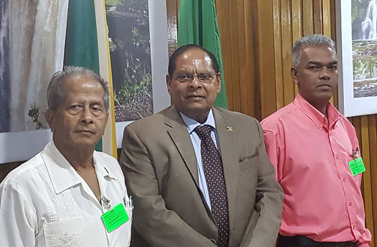 Prime Minister Moses Nagamootoo is flanked by GAWU, President Komal Chand and Lochan Nagassar