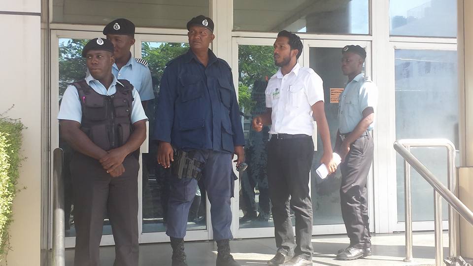 Police officers and a court marshal outside the bank on Tuesday.