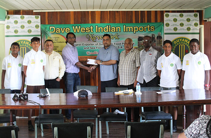 Representative of Dave West Indian Imports, Amar Ramraj handing over the sponsorship cheque to the treasure of the GCB, Anand Kalladeen. Also sharing the moment are Marketing Manager Raj Singh (third right), acting president of the local governing body, Fizul Bacchus (fourth right), Chairman of the GCB’s Competitions Committee Colin Europe (third right), along with some Under-15 cricketers