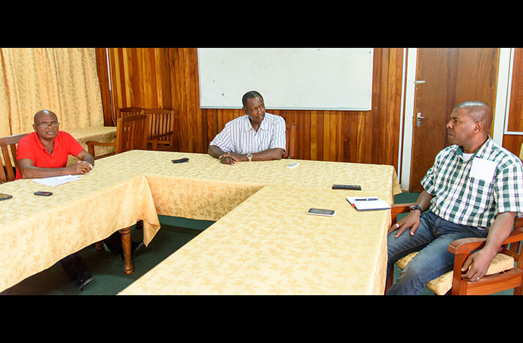 Locked in discussion are, from left, GBGWU Vice-President, Garfield Brutus; General Secretary, Lincoln Lewis; and President, Ephraim Velloza (Photo by Samuel Maughn)