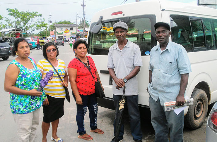 Chairman of the Moblissa’s Community Development Council, Arthur Reynolds (right) and residents of the Moblissa community pose behind the bus donated by the Ministry of Indigenous People’s Affairs