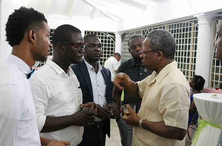 UGSS President, Norwell Hinds (second left) and Vice-Chancellor of UG, Professor Ivelaw Griffith, in conversation last year