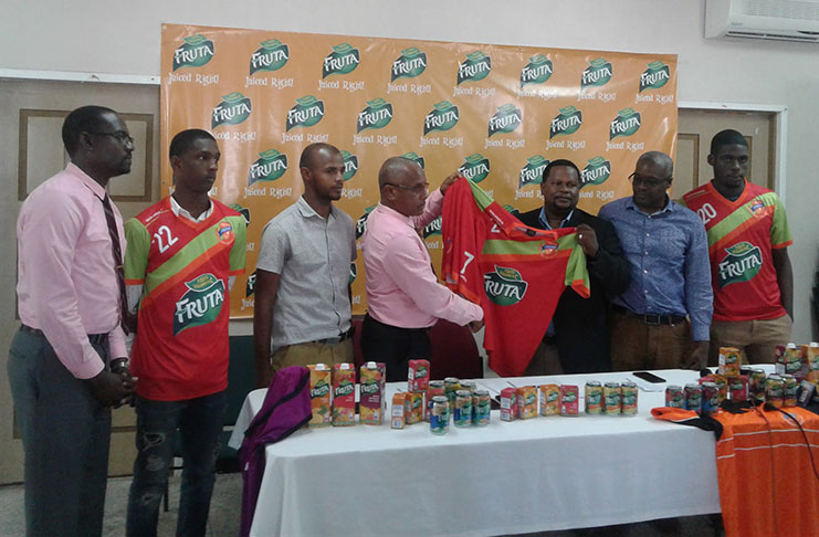 Samuel Arjoon (3rd from right), Commercial Manager of GBI, hands over the symbolic jersey to Fruta Conquerors assistant secretary/treasurer Jolyan Lewis. From left to right - Club secretary Daniel Wilson, player Nicholas MacArthur, Club vice-president Colin Gittens, Andre Noel, Category Manager Juices, SM Jaleel and player Jeremy Garrett.
