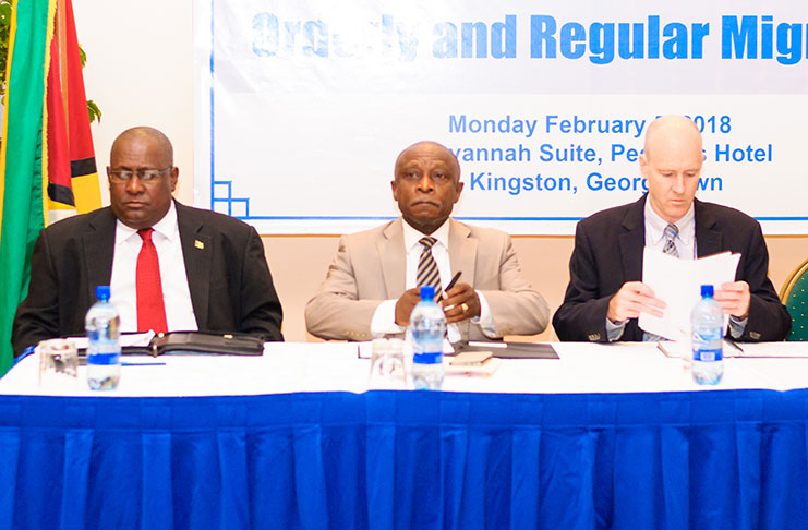 Acting Prime Minister and Minister of Foreign Affairs, Carl Greenidge flanked by Ambassador Michael Brotherson and IOM Regional Coordination Officer for the Caribbean and Chief of Mission in Guyana, Robert Natiello, seated at the head table.