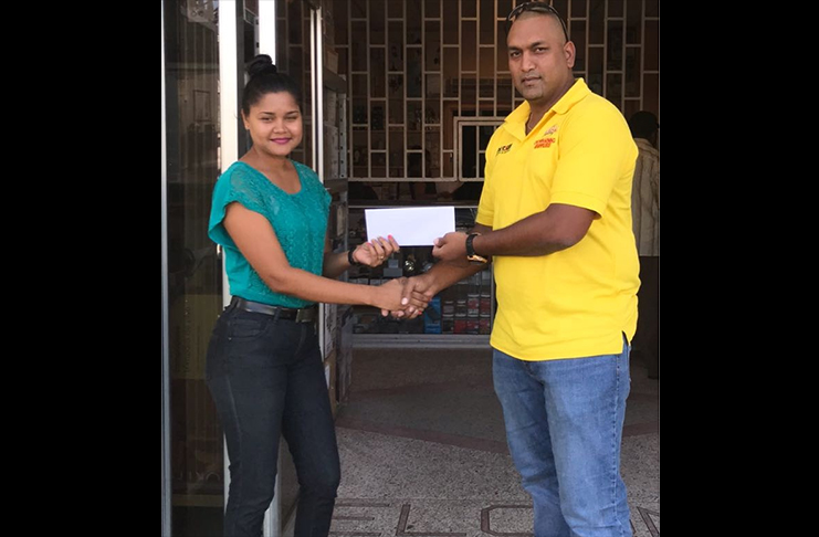 Darshini Narine (left) handing over the timely sponsorship to Parmanand Persaud