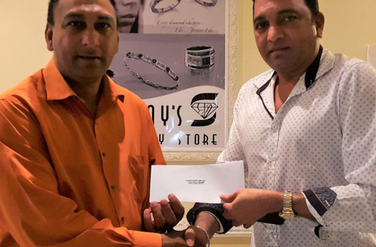 Lusignan Golf Club president Aleem Hussain (left) receives the sponsorship cheque from Sanjay Persaud