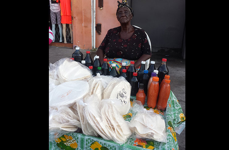 Eighty-year-old Maureen Lewis also called "Granny" at her cassava stand on Regent Street