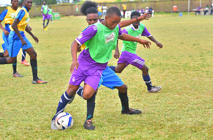 Part of the action in Sunday’s Milo Schools football semi-finals play at the Ministry of Education ground on Carifesta Avenue. (Samuel Maughn photo)