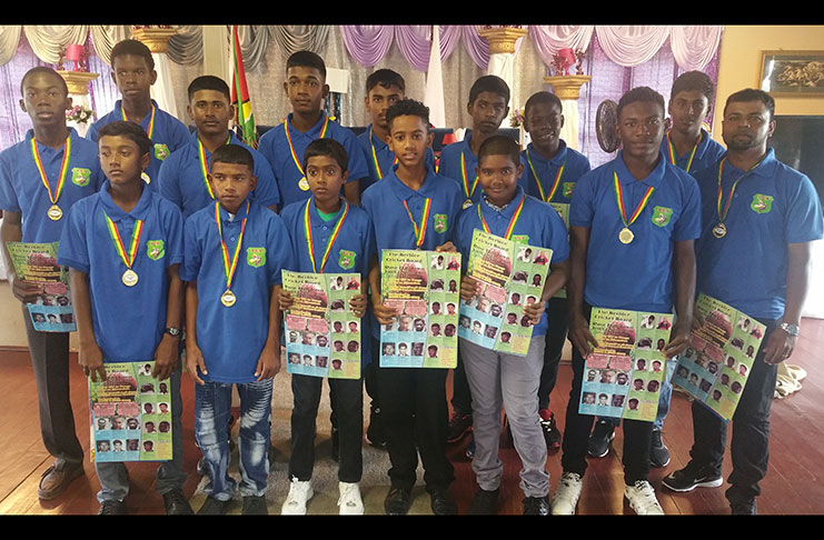 BCB U-15 team decked out in blue BCB T-shirts Their manager (far left) poses with their medals.