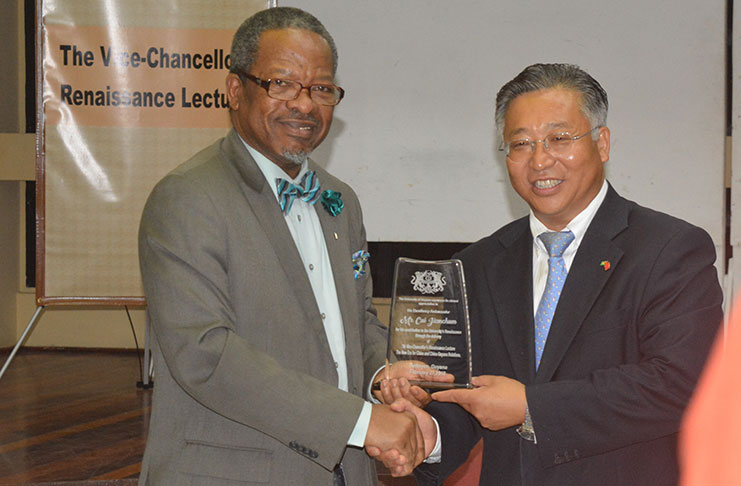 Ambassador of the People’s Republic of China to Guyana, Cui Jianchun, receives an award for his contribution to the University of Guyana (UG) Renaissance Lecture Series, presented by Principal and Vice-Chancellor, Professor Ivelaw Griffith (photo by Lisa Hamilton)