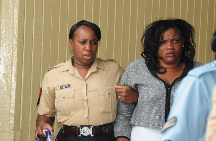 Rutherford being led away from the High Court by the police after she was found guilty
of two counts of manslaughter, which caused her to seemingly faint several times