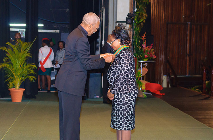 President David Granger conferring Justice Yonette Cummings-Edwards with the insignia of the Order of Roraima