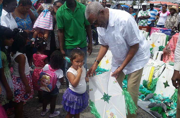 President Granger trying to gain the interest a toddler in one of his colourful little presents