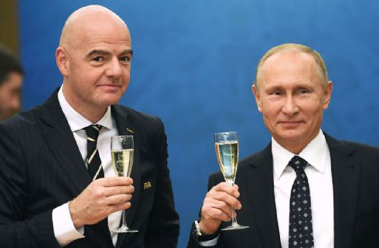 Russia president Gianni Infantino, left, and Russia president Vladimir Putin, right, at the group-stage draw in December. Michael Regan/FIFA via Getty Images.