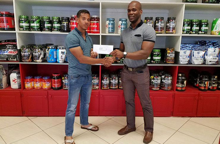 Jamie McDonald (left) of Fitness Express hands over the sponsorship package to GBBFF president Coel Marks.