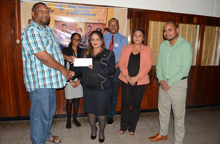 GNNL Chairperson Geeta Chandan-Edmond hands over the sponsorship cheque to BCB president Hilbert Foster in the presence of other directors and staff.
