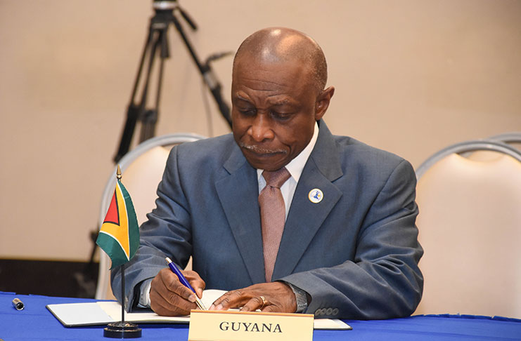 Vice-President and Foreign Affairs Minister Carl Greenidge signing the agreements on behalf of Guyana in Port-au-Prince, Haiti