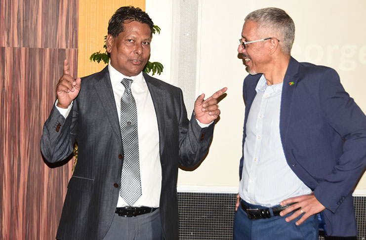 Businessman Robert Badal chats with Minister of Business Dominic Gaskin at the Pegasus Hotel on Thursday evening