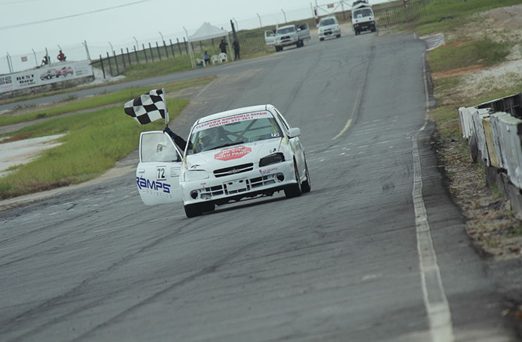 Raymond Seebarran displays his chequered flag