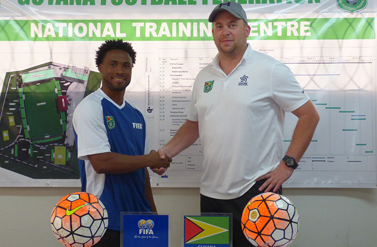 GFF Technical Director Ian Greenwood (right) welcomes Vurlon Mills to the GFF.