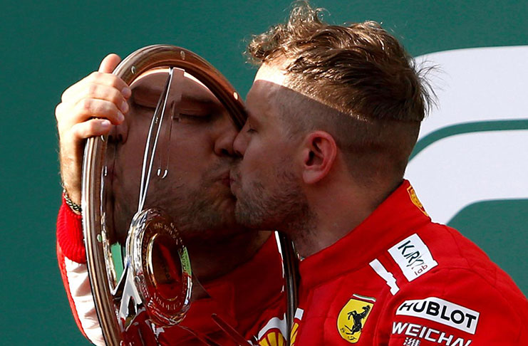 Ferrari's Sebastian Vettel celebrates his win on the podium with the trophy REUTERS/Brandon Malone TPX IMAGES OF THE DAY