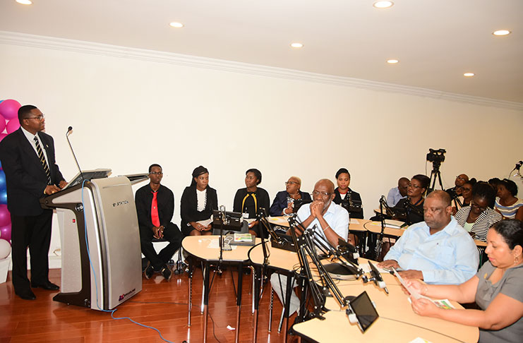 Permanent Secretary of Department of the Public Service and Ministry of the Presidency, Reginald Brotherson, addresses the gathering on the work of the scholarship programme over the years. (photo by Adrian Narine)