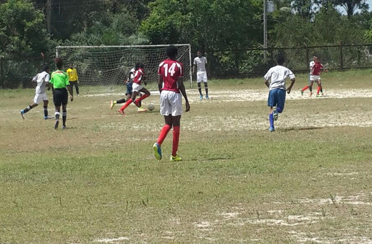 A Milerock player (number 14) watches as his teammate makes an attempt on goal against Hi Stars