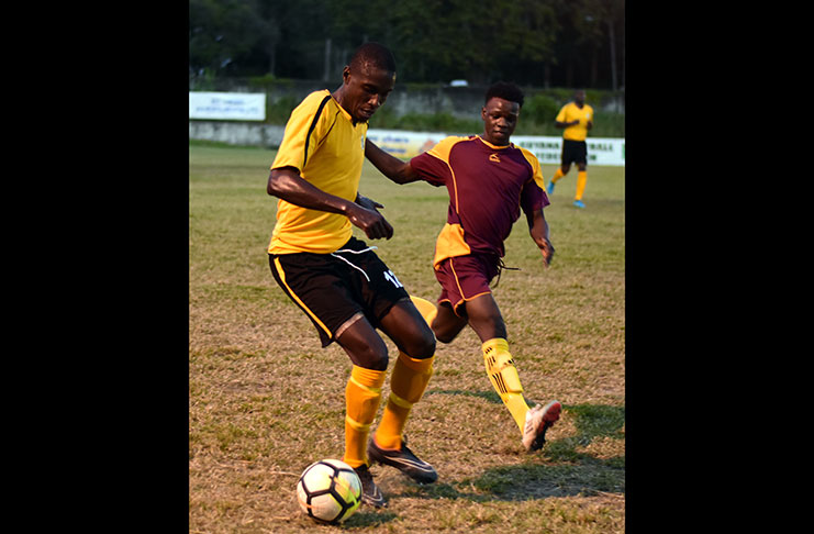 Action between the Western Tigers (Yellow) and Cougars FC (Maroon) (Adrian Narine photo)