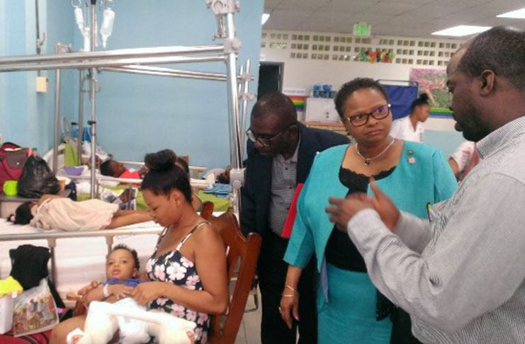 One of the surgeons (Dr Watson at extreme right), explains to Minister Lawrence the recovery phase of each of the patients