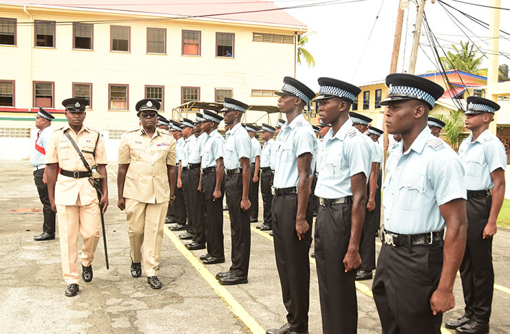 Assistant Commissioner of Police Nigel Hoppie (second from left) inspects the  recruits (Adrian Narine photo)