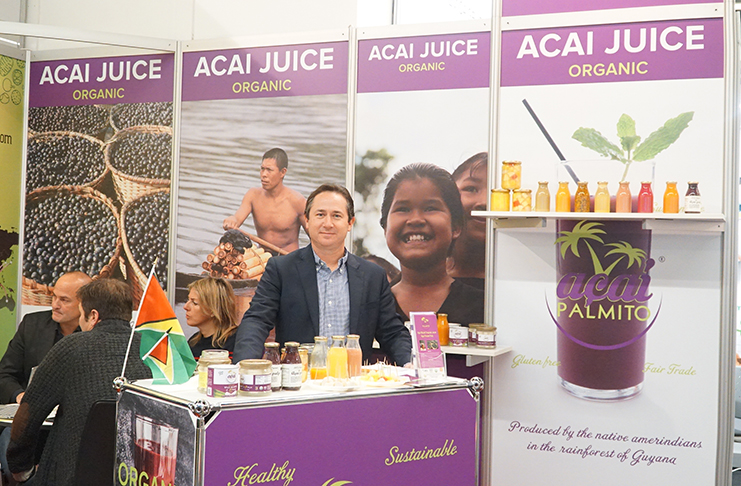 Managing Director of Amazon Caribbean Guyana Limited (AMCAR), Christophe Sureau, showcases açai berries pulp, Acai Palmito, organic pineapple juice and other tropical fruits at a recent expo overseas (Photos by AMCAR)