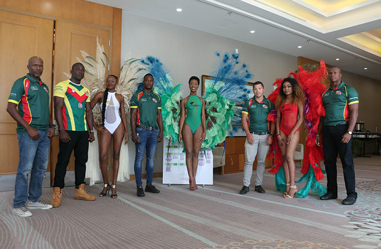 From left, Shane Grant-Stuart, Avery Corbin, Blaise Bailey, Ryan Gonsalves and Dwayne Schroder are joined by the Guyana Carnival models at the Marriott Hotel at the launch of the Guyana Carnival. (Adrian Narine photo)