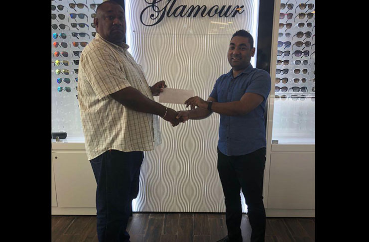 Gizmos & Gadgets’ Ravi Mangar hands over sponsorship cheque to RHTYSC Secretary/CEO Hilbert Foster.