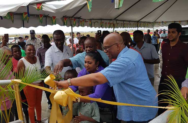 Finance Minister Winston Jordan helps to cut  the ribbon to open the Dartmouth Centre