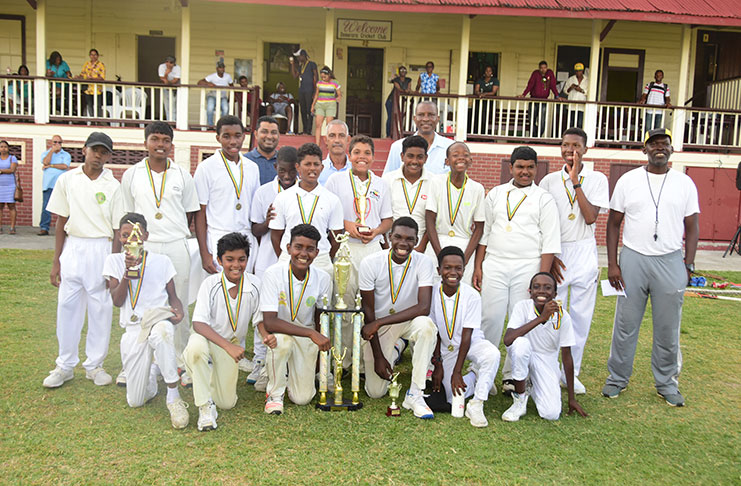 We are the best of Demerara! GCA/Toucan Distributors U-15 50-overs champions DCC, pose with their winning trophy (Adrian Narine photo)