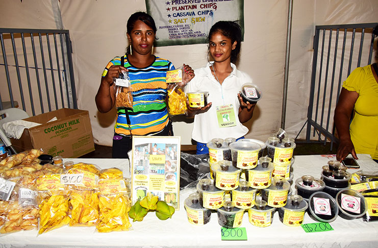 These exhibitors proudly display their products at the opening of the Regional Agricultural and Commercial Exhibition
(RACE) at the Leonora stadium on Saturday (Adrian Narine photo)