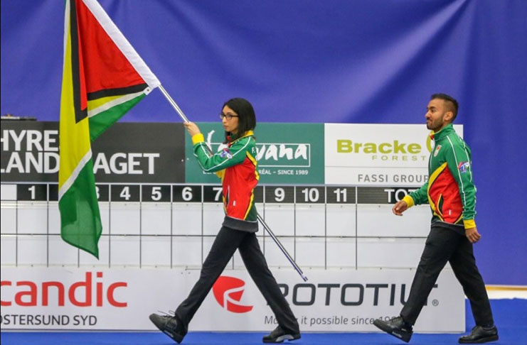 Guyana’s Rayad and Farzana Hussain carrying the ‘Golden Arrowhead’ at the opening of the 2018 World Mixed Doubles Curling Championship in Östersund, Sweden, yesterday.