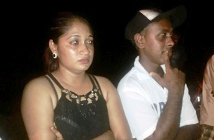 Ganesh Budhoo and his wife look on helplessly at what’s left of their home