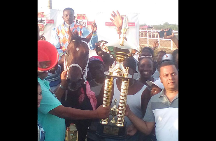 Connections of the Jagdeo stables receive the winning trophy for Just Call Me Boss victory.