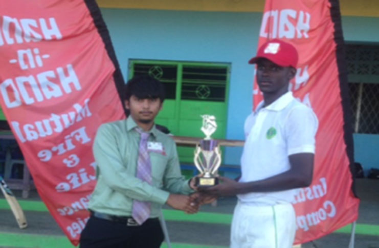 Man-of-the-Match Junior Sinclair receives his prize from Hand-in-Hand representaive Sachin Kanhai  (at left)