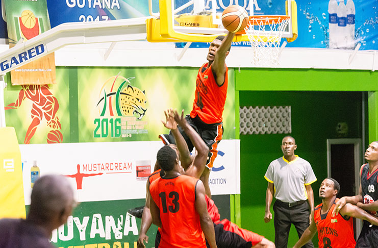 Ravens centre Anthony Moe caught by Chronicle Sport photographer Samuel Maughn blocking a shot attempt by Kobras point Guard Travis Burnett.