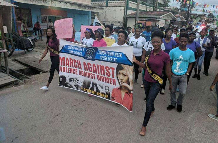 Two delegates leading the march denouncing violence against women and girls