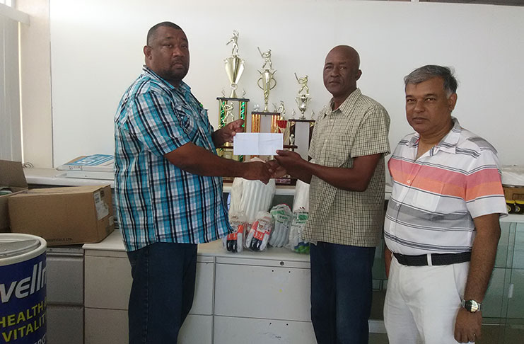 Wayne Jones of Mike’s Pharmacy hands over the sponsorship cheque to BCB president Hilbert Foster while the company’s CEO Lakhram Singh looks on.